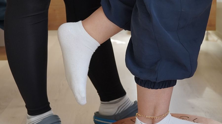 A patient doing balance board work during a rehabilitation session