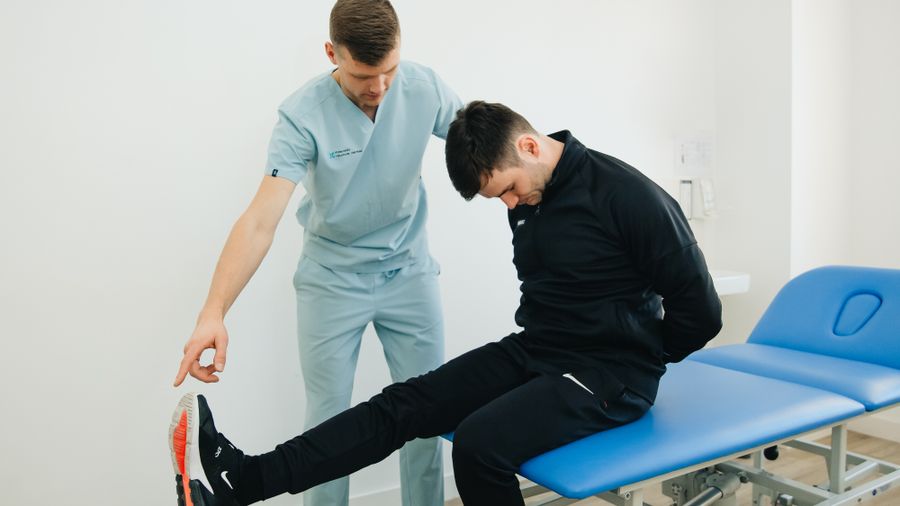 A physiotherapist talking a patient through a rehabilitation exercise